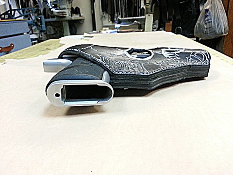 Side view of an extra thick hand tooled holster