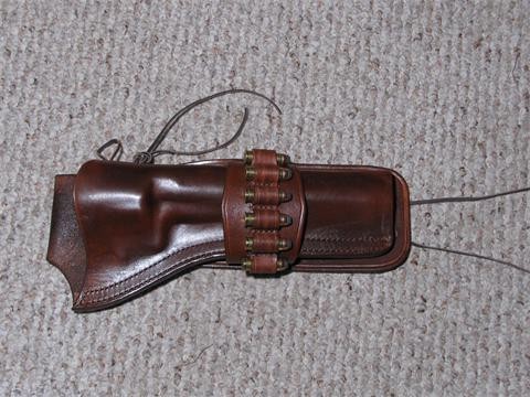 Belt mount molded holster with wrap around ammo strap and tie downs