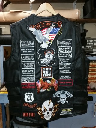 A Biker's vest with embroidered patches sewn on